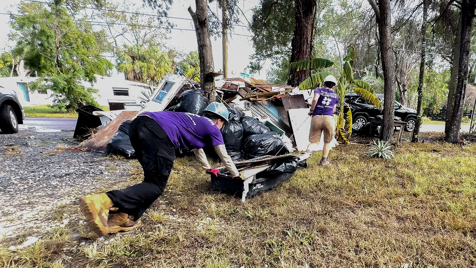 Volunteer clear debris after Hurricane Helene