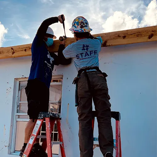 Team members work together on a ladder