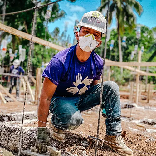 Image of a kneeling volunteer