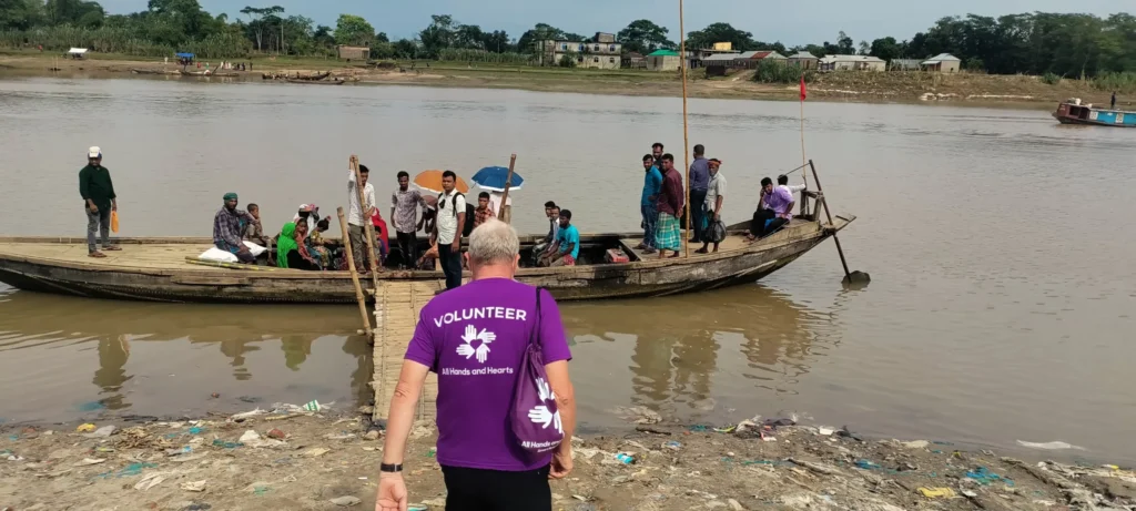 Volunteer boards a wooden boat
