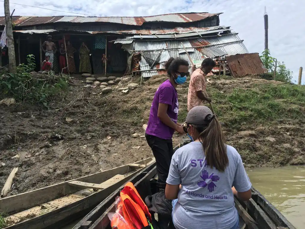 Staff member on boat assessing cyclone damage