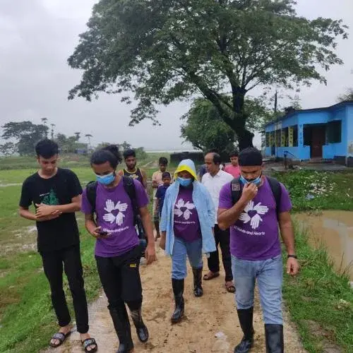 A group of volunteers walking with community members