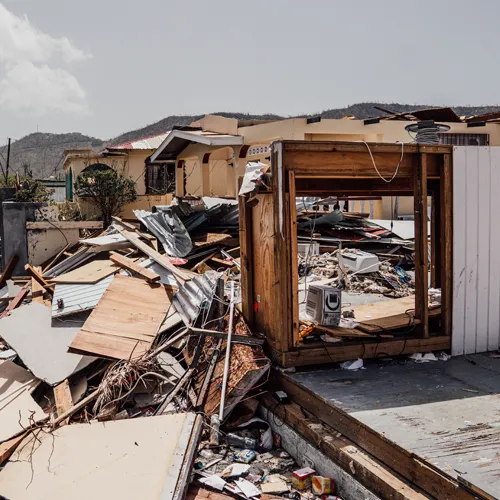 Collapsed home filled with debris and broken wood after Hurricane Beryl destruction in Grenada.