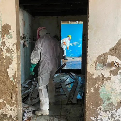 Workers clean a flood damaged home