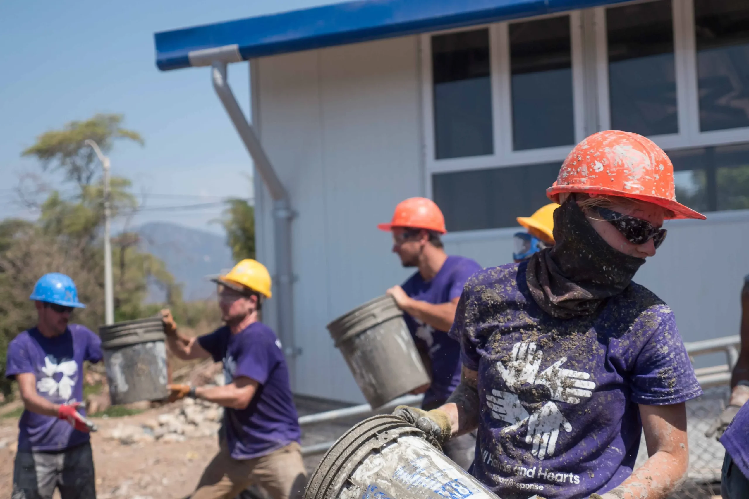 Volunteers work to rebuild a home