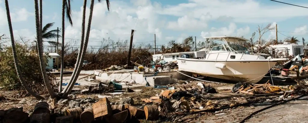 Damaged boat stranded among debris and destroyed property after a hurricane in the Florida Keys.