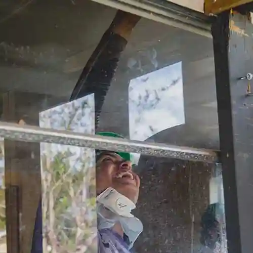 Relief volunteer in Florida works on storm-damaged interior, repairing ceiling and insulation after Hurricane Michael.