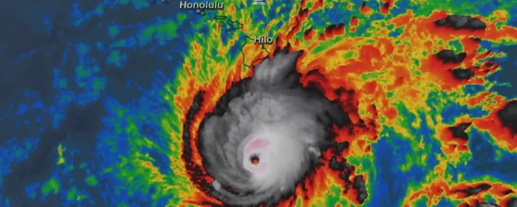 Satellite image showing a powerful hurricane approaching Hawaii, with the storm’s eye clearly visible near Hilo and Honolulu marked on the map.