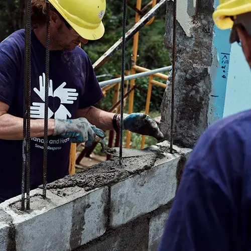 Volunteers build a wall