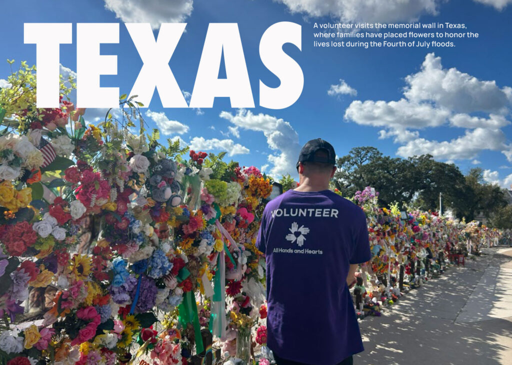 A volunteer visits the memorial wall in Texas, where families have placed flowers to honor the lives lost during the Fourth of July floods.