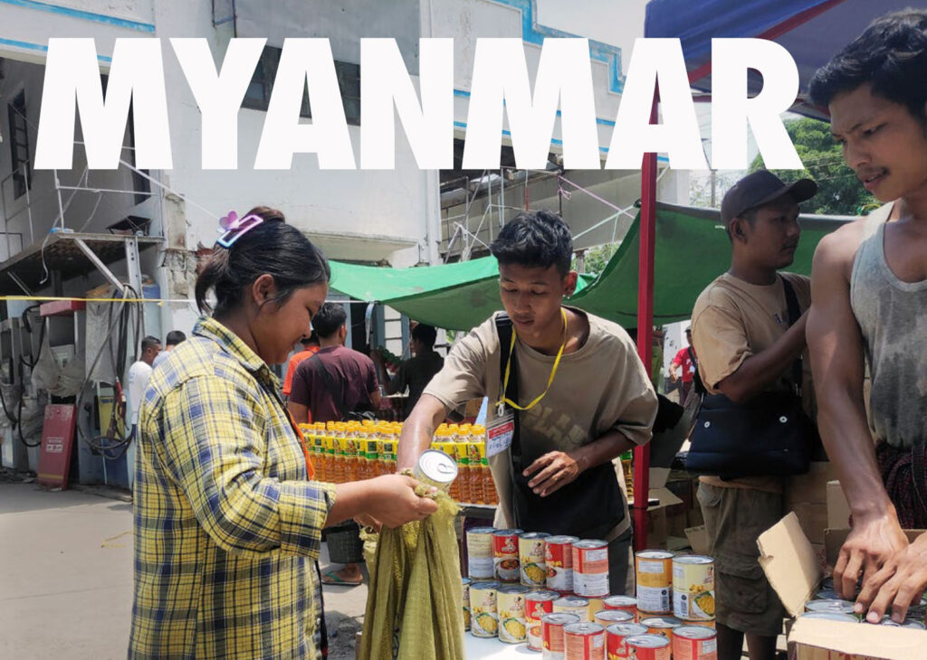 Image of volunteers distributing canned goods in Myanmar
